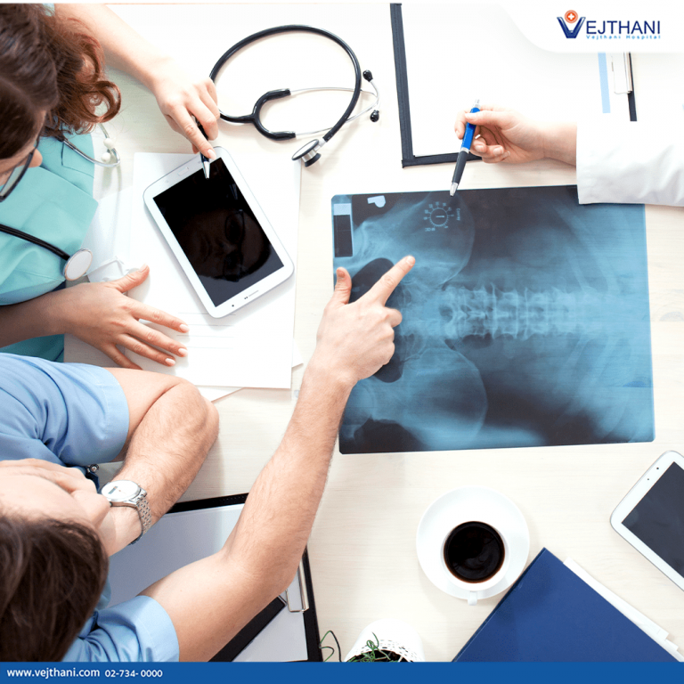 A team of orthopedic surgeons discuss an x-ray and consider the best treatment to meet a patient’s needs.