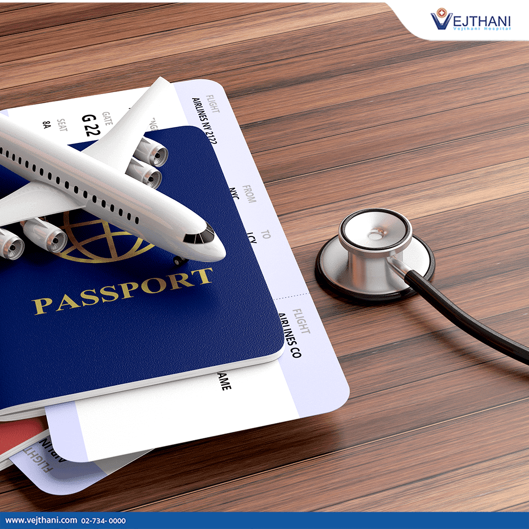 A stethoscope laying on a wood table next to two passports with airline tickets inside them.